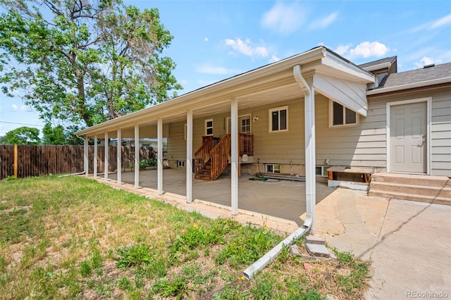 335 N 11th Ave, Brighton, CO 80601 - back of property with a patio area and entry steps