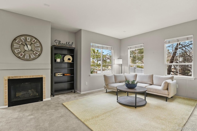 carpeted living room with a tile fireplace