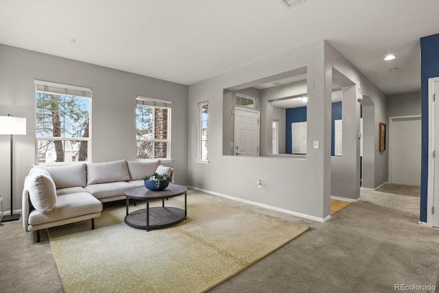 living room featuring plenty of natural light and light colored carpet