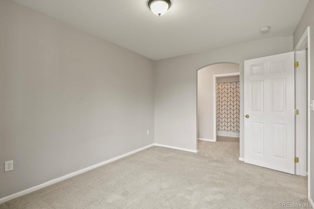 empty room featuring light colored carpet