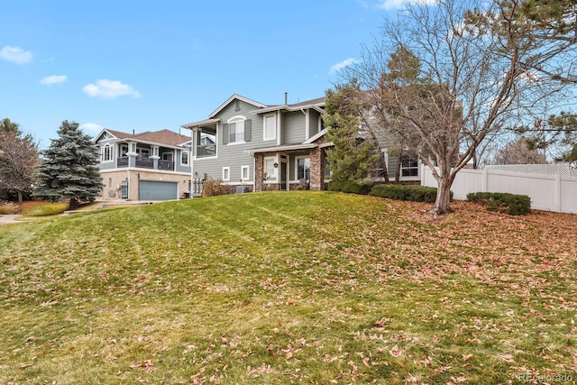 view of front of property with a front yard and a garage