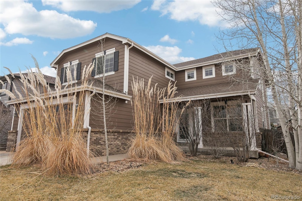 exterior space with a yard and roof with shingles