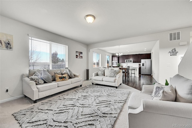 living room with hardwood / wood-style flooring and a notable chandelier