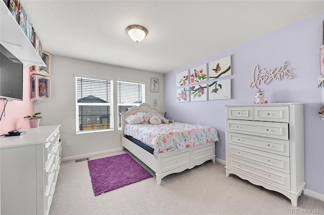 carpeted bedroom with a textured ceiling