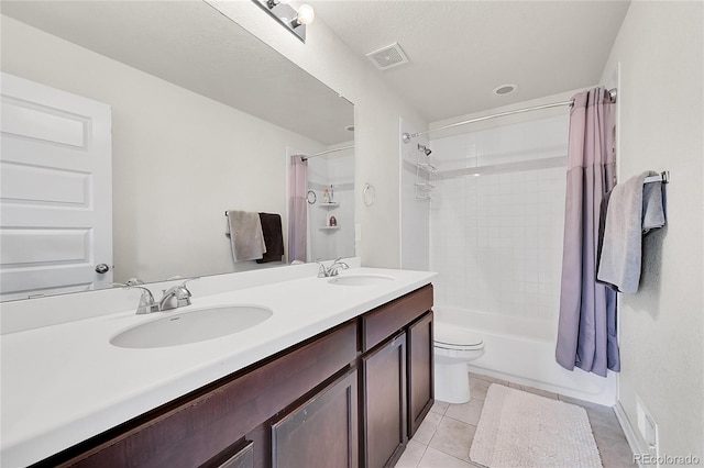 full bathroom with tile patterned flooring, vanity, shower / tub combo, and toilet