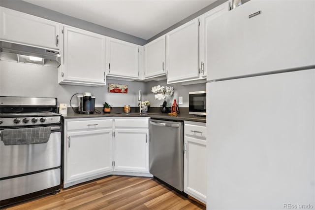 kitchen with sink, light hardwood / wood-style floors, white cabinets, and appliances with stainless steel finishes