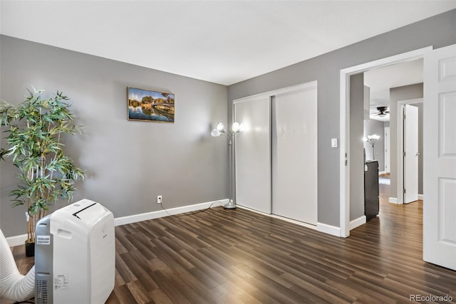 interior space with dark wood-type flooring and a closet