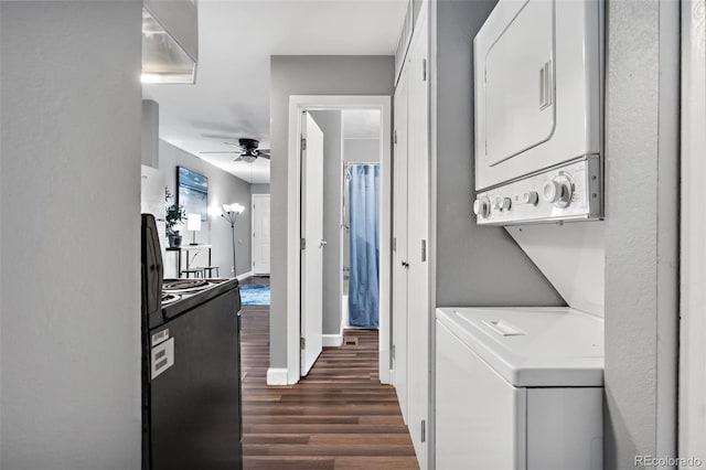 laundry area featuring dark wood-type flooring, ceiling fan, and stacked washer and clothes dryer