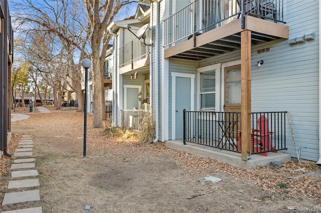 view of side of property with a balcony