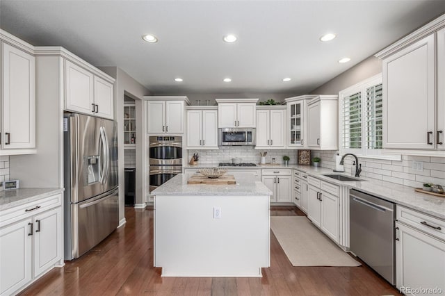 14258 Greenfield Loop, Parker, CO 80134 - kitchen with appliances with stainless steel finishes, a sink, tasteful backsplash, recessed lighting, and a center island