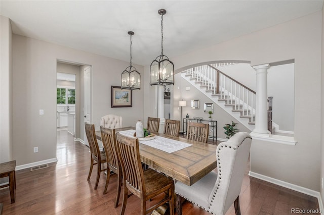 14258 Greenfield Loop, Parker, CO 80134 - dining area featuring wood finished floors, baseboards, stairs, decorative columns, and arched walkways