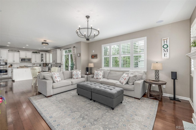 14258 Greenfield Loop, Parker, CO 80134 - living area with a chandelier, dark wood-style floors, recessed lighting, and baseboards