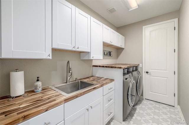 14258 Greenfield Loop, Parker, CO 80134 - laundry room featuring washer and clothes dryer, cabinet space, light flooring, and baseboards