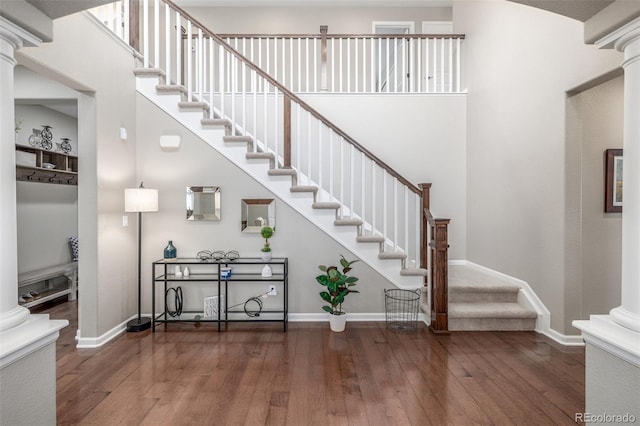 14258 Greenfield Loop, Parker, CO 80134 - stairs featuring decorative columns, hardwood / wood-style floors, and baseboards