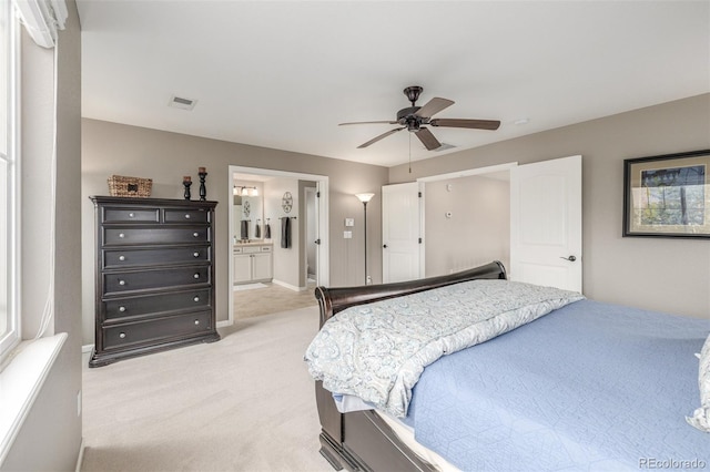 14258 Greenfield Loop, Parker, CO 80134 - bedroom with light colored carpet, ensuite bathroom, a ceiling fan, and baseboards