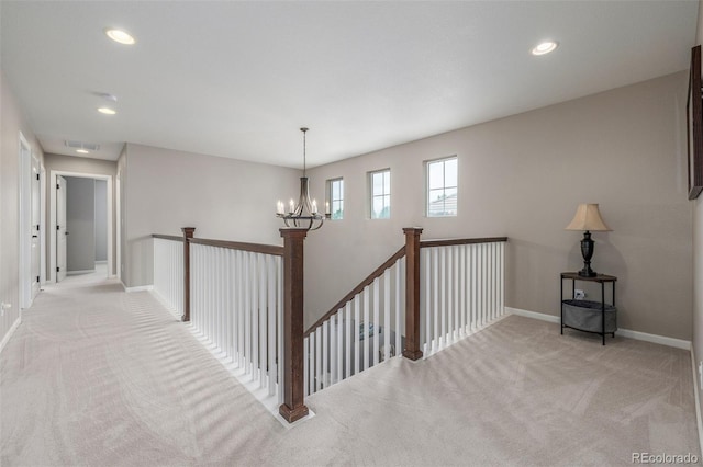 14258 Greenfield Loop, Parker, CO 80134 - hall with light carpet, an upstairs landing, a chandelier, baseboards, and recessed lighting