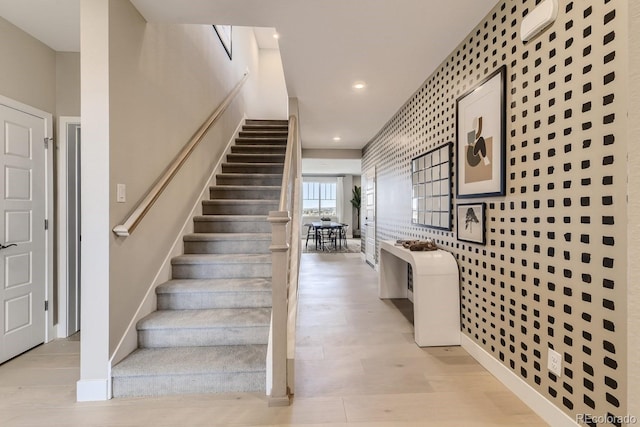 staircase with hardwood / wood-style flooring