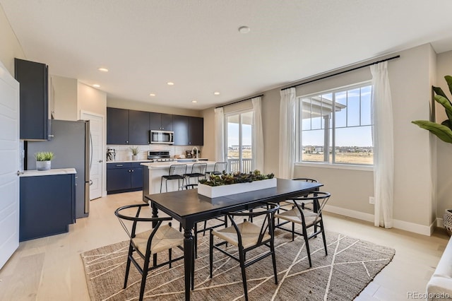 dining space with light hardwood / wood-style floors