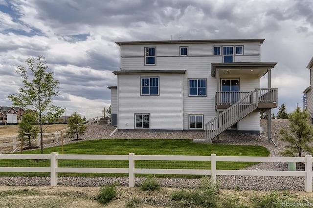 rear view of house featuring a yard