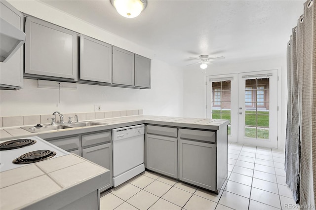 kitchen featuring kitchen peninsula, ceiling fan, tile countertops, dishwasher, and gray cabinets