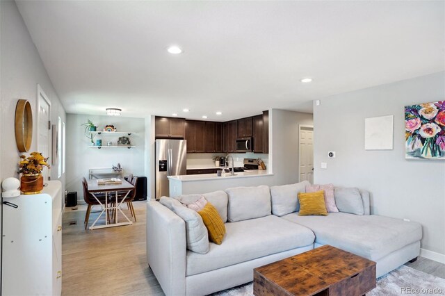 4080 Adams St, Denver, CO 80216 - living room with light wood-type flooring, baseboards, and recessed lighting