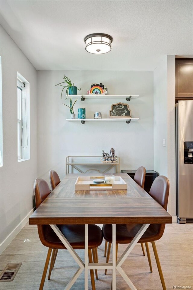4080 Adams St, Denver, CO 80216 - dining room with light wood-type flooring and baseboards