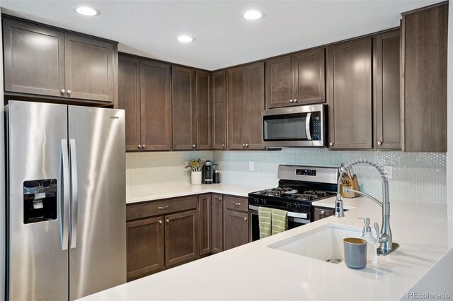 4080 Adams St, Denver, CO 80216 - kitchen featuring appliances with stainless steel finishes, a sink, light countertops, dark brown cabinets, and recessed lighting