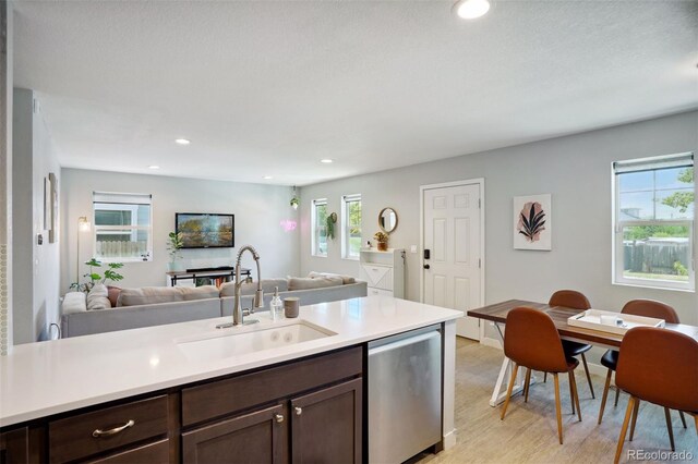4080 Adams St, Denver, CO 80216 - kitchen featuring open floor plan, a sink, dark brown cabinets, light countertops, and recessed lighting