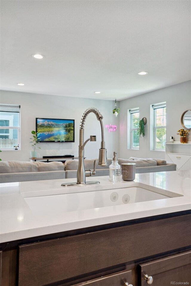 4080 Adams St, Denver, CO 80216 - detailed view of dark brown cabinets, a sink, light countertops, and recessed lighting