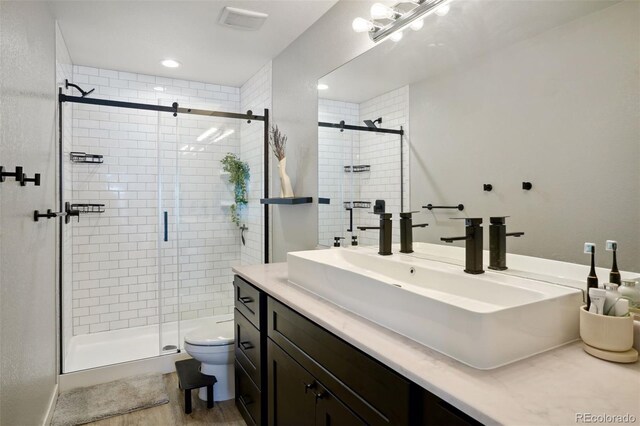4080 Adams St, Denver, CO 80216 - bathroom with toilet, a shower stall, vanity, and wood finished floors