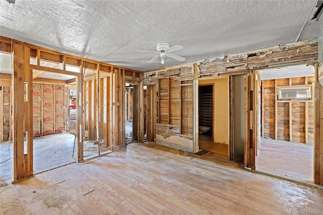 660 K Ave, Limon, CO 80828 - misc room with ceiling fan, wood finished floors, a textured ceiling, and a wall unit AC