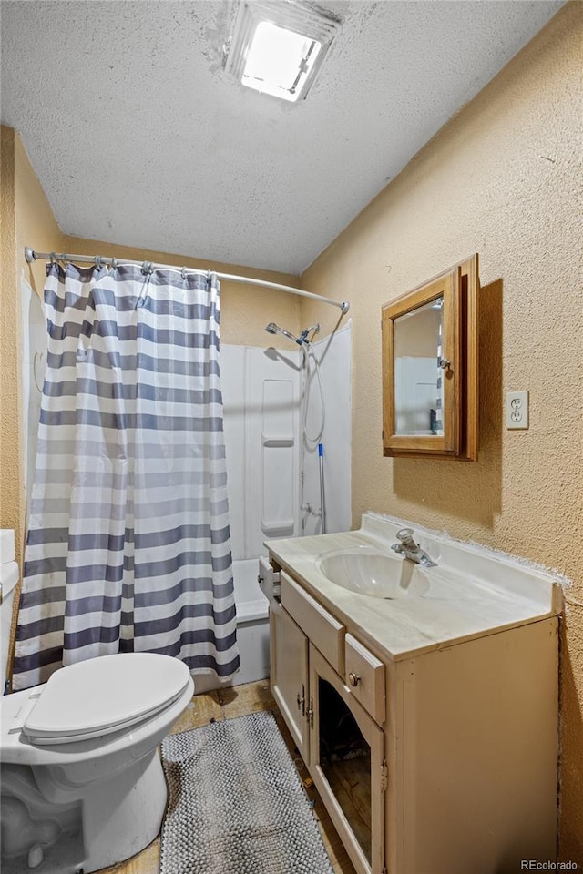 660 K Ave, Limon, CO 80828 - full bath featuring vanity, a textured ceiling, toilet, a textured wall, and shower / bath combination with curtain