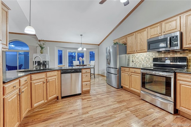 kitchen featuring ornamental molding, a sink, stainless steel appliances, light wood-style floors, and lofted ceiling