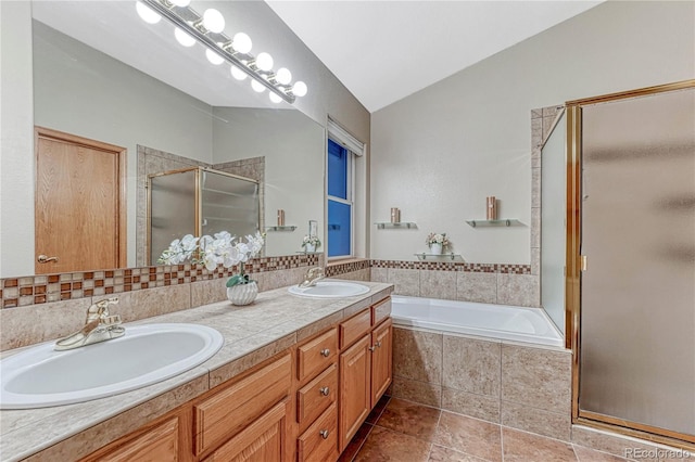 full bath featuring a bath, vaulted ceiling, a stall shower, and a sink