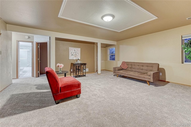 living room featuring baseboards, carpet, visible vents, and a textured ceiling