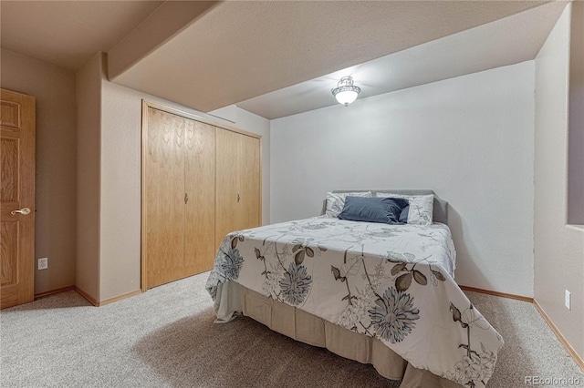 bedroom with a closet, baseboards, and carpet flooring