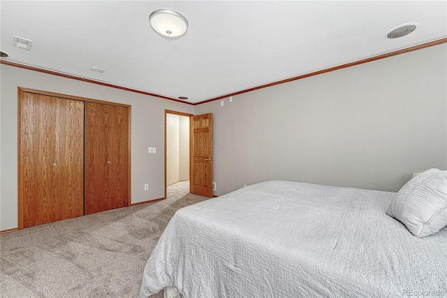 bedroom featuring visible vents, carpet, a closet, and ornamental molding