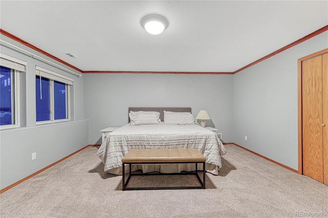 carpeted bedroom with baseboards, visible vents, and ornamental molding