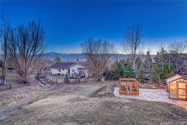 exterior space with an outdoor structure, fence, and a mountain view