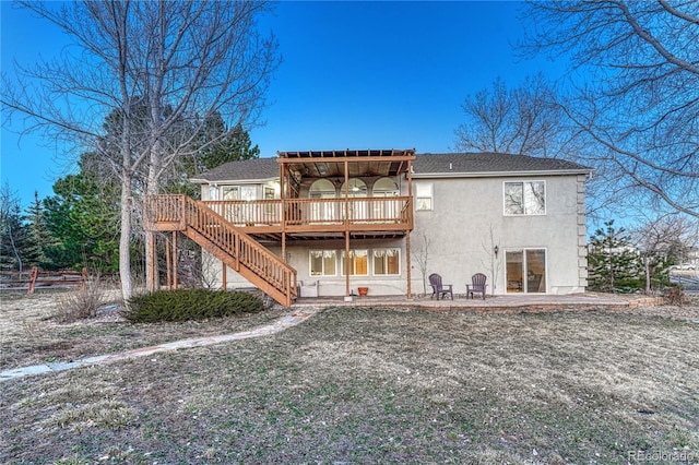 back of house with a deck, stairway, a patio area, and stucco siding