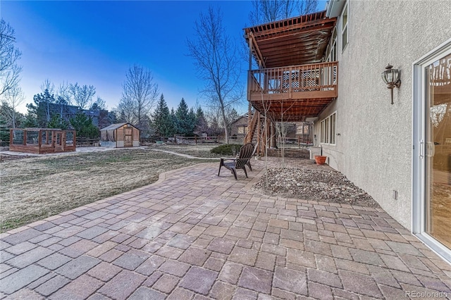 view of patio featuring an outbuilding and a shed