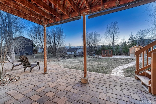 view of patio featuring an outbuilding