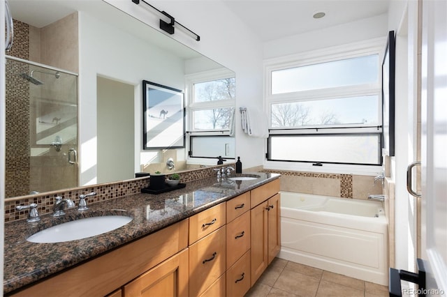 bathroom featuring tile patterned flooring, vanity, and plus walk in shower