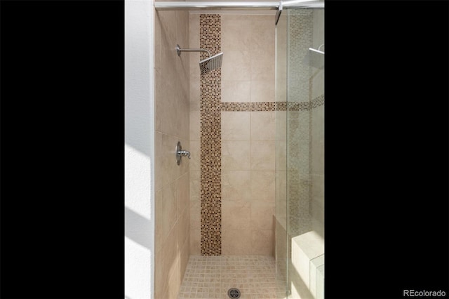 bathroom with tiled shower