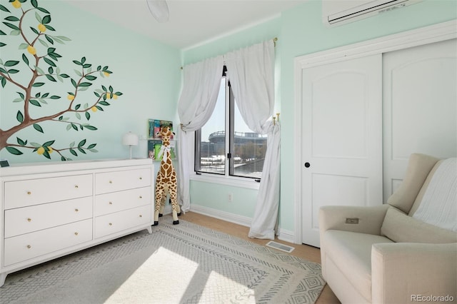 living area with an AC wall unit