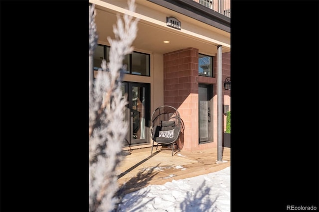 view of snow covered property entrance