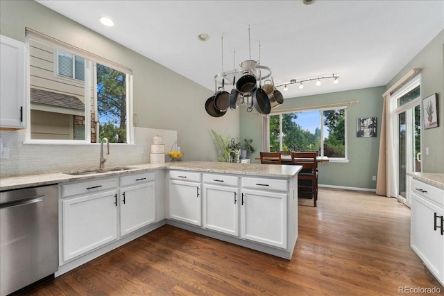 5370 S Gray St, Littleton, CO 80123 - kitchen with dishwasher, a peninsula, tasteful backsplash, a chandelier, and white cabinetry