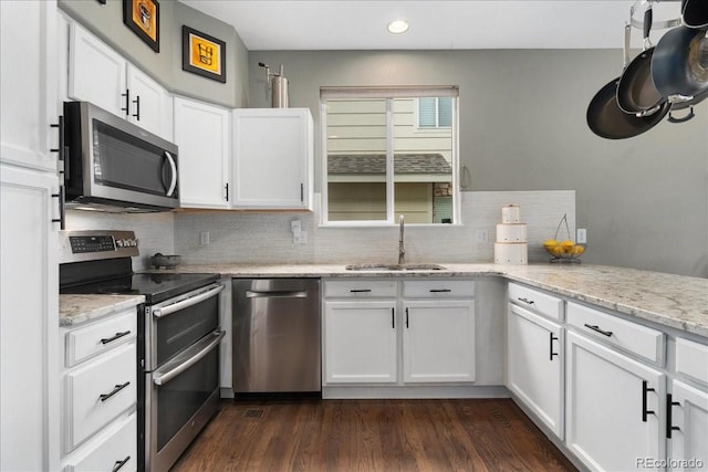 5370 S Gray St, Littleton, CO 80123 - kitchen with stainless steel appliances, tasteful backsplash, white cabinets, recessed lighting, and light stone counters