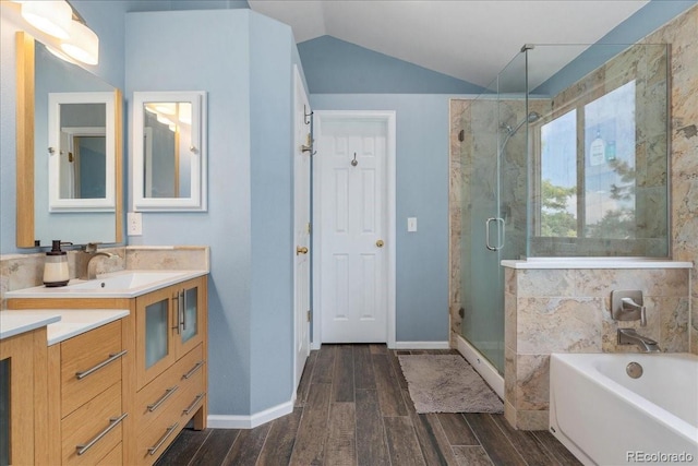 5370 S Gray St, Littleton, CO 80123 - full bathroom with vanity, wood finished floors, a stall shower, a garden tub, and vaulted ceiling