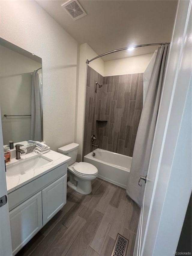 full bathroom with wood finished floors, vanity, toilet, and shower / bath combination with curtain